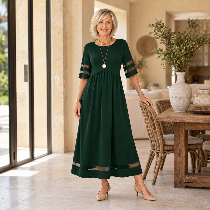 Aubrey midi dress in Green, worn by a mature blonde woman in a Mediterranean home