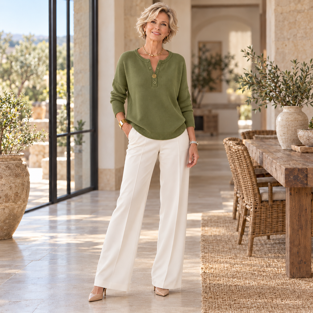 Helena™ | Henley Button-Up Knit Sweater worn by a mature blonde woman in a sunlit Mediterranean home