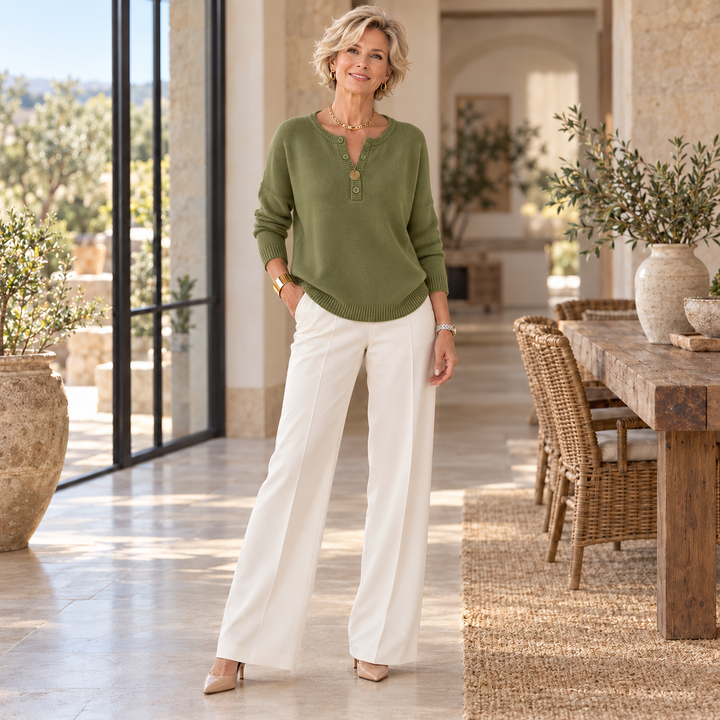 Helena™ | Henley Button-Up Knit Sweater worn by a mature blonde woman in a sunlit Mediterranean home