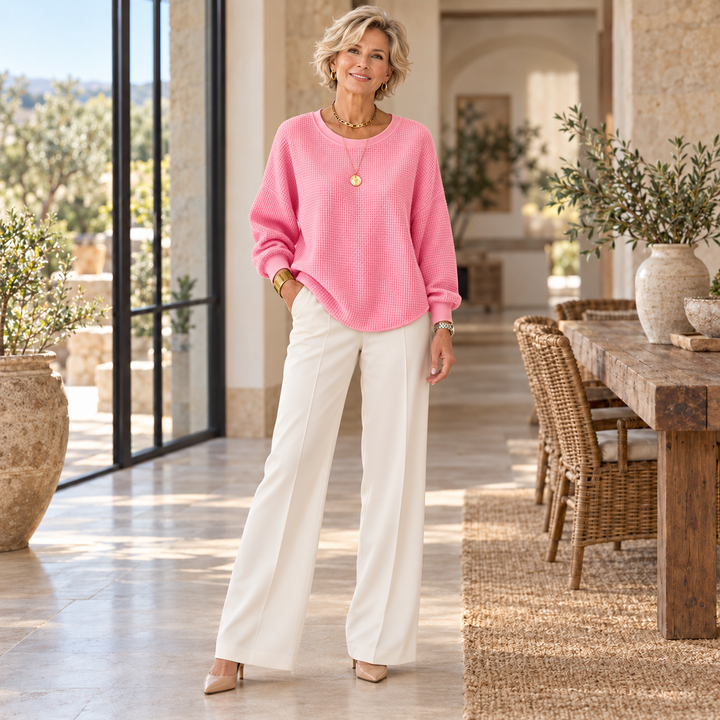 Nyla™ | Classic Sweater worn by a mature blonde woman in a sunlit Mediterranean home